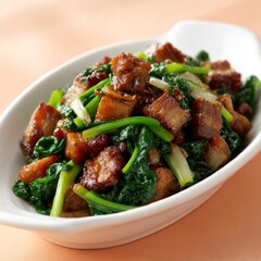 Thai-style crispy pork belly with kale served on a clean white plate, creamy peach tones and gentle lighting enhance the textures.