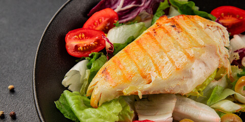 Grilled chicken breast salad chicken breast tomato, green leaf lettuce, salad mix snack vegetable tasty snack fresh gourmet food background on the table rustic top view copy space keto and paleo diet