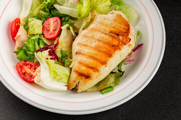 Grilled chicken breast salad chicken breast tomato, green leaf lettuce, salad mix snack vegetable tasty snack fresh gourmet food background on the table rustic top view copy space keto and paleo diet