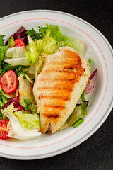 Grilled chicken breast salad chicken breast tomato, green leaf lettuce, salad mix snack vegetable tasty snack fresh gourmet food background on the table rustic top view copy space keto and paleo diet