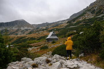 Hiker Approaching Mountain Cabin in Autumn