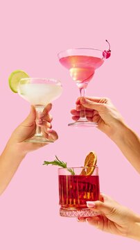 Loop animation. Variations of alcohol drinks. Capturing hands with funky cocktail glasses, each hosting a uniquely colorful drink, set against colorful studio background. Concept of party, mix.