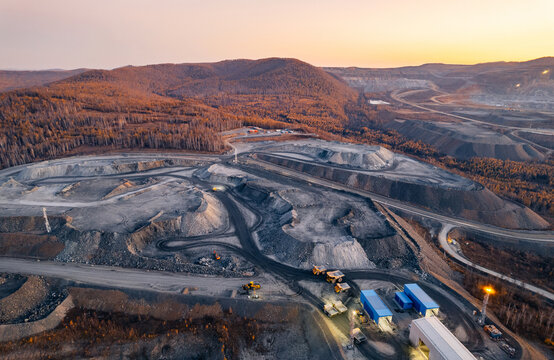 Night open pit mine, extractive industry for gold and copper ore, top view aerial drone