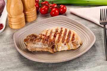 Grilled pork loin steak with bone