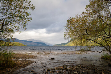 A cloudy, autumnal HDR image of Loch Lomond looking north taken from Firkin Point picnic site near Inverbeg, Scotland. 