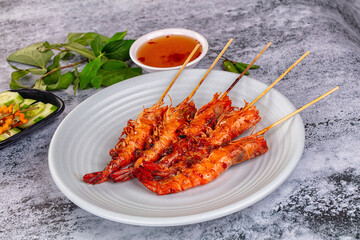Grilled prawn skewer served sauce