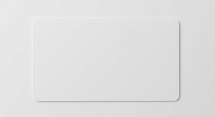 A solid white rectangular object with rounded corners sits on a matching surface