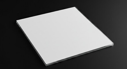 A square white object encased in clear plastic rests diagonally against a dark backdrop