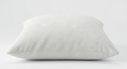 A textured rectangular white pillow sits on a light bright surface