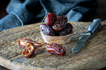 Medjool dates on a rustic wooden cutting board. 