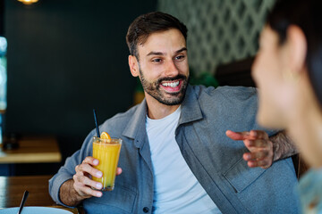 Portrait of ayoung romantic couple in restaurant having lunch