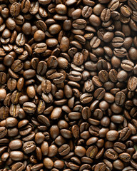 A top down view of a pile of whole coffee beans.