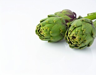 Obraz premium Two fresh raw artichokes isolated on white background. Top view.