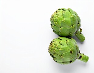 Fototapeta premium Two fresh raw artichokes isolated on white background. Top view.