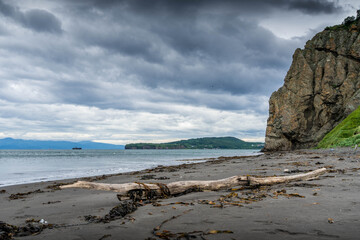 Kamchatka coast with black volcanic sand beach, Russia, popular for outdoor tourism.

