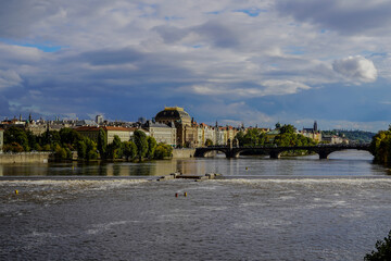 Beautiful Aerial view of Pragues National Theatre (Národní divadlo) at night with view of the city and the Vltava
