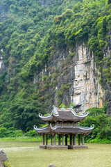 Floating temple in a lake at the Trang An Scenic Landscape Complex, Ninh Binh, Vietnam. Tam Coc National Park Sightseeing tour to grottoes.