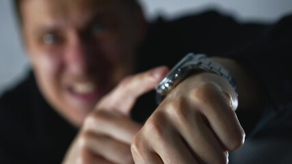 The boss points to his wristwatch and says he has no time.
The man gestures that he's late and has no time.
The man is rushing someone and asking them to hurry up.