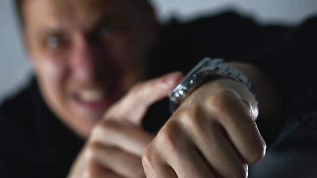 The boss points to his wristwatch and says he has no time.
The man gestures that he's late and has no time.
The man is rushing someone and asking them to hurry up.