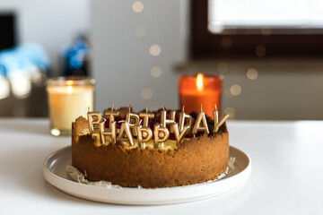cheesecake birthday cake with raspberries and candles