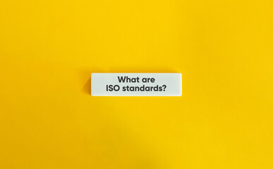 What Are ISO Standards Question on White Tile over Yellow Background – Minimal Business and Quality Concept