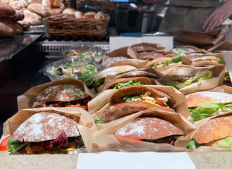 Ready to eat club sandwich with bakery items background.