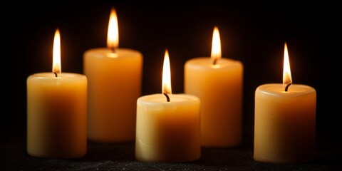 A serene arrangement of five glowing candles, each flickering with warm light, creating a tranquil and inviting ambiance that enhances any space.