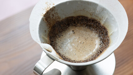 barista quick metal filter coffee brewing close up	