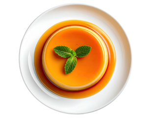 Overhead shot of a glossy caramel custard dessert with mint garnish on a white plate
