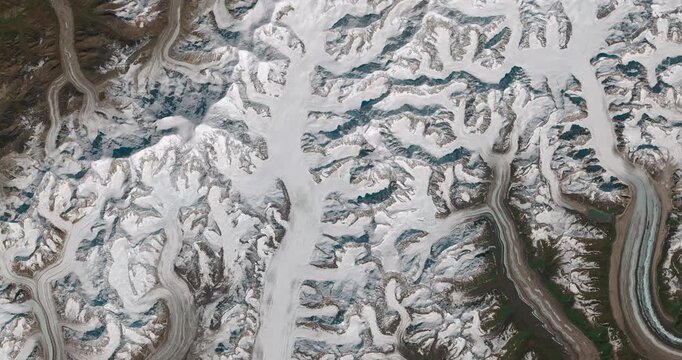 Aerial shot of snowy mountains, valleys and glaciers. Camera is moving forward and left. Animation based on image by NASA
