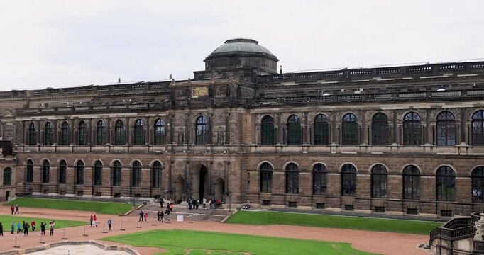 Dresden Germany Zwinger palace courtyard tourist 4K. Industrial center of East Germany, now unified German, European Union (EU) and NATO. Total destruction in WW II. Palace rebuilt historically.