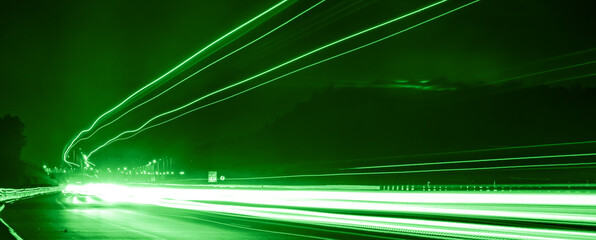 green car lights at night. long exposure
