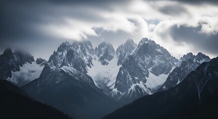 Naklejka premium Dramatic mountain range under cloudy skies majestic peaks and landscape