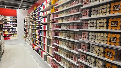 Brightly lit aisle of a store filled with various craft supplies and decorating items