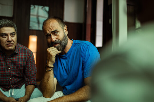 Men in group therapy session