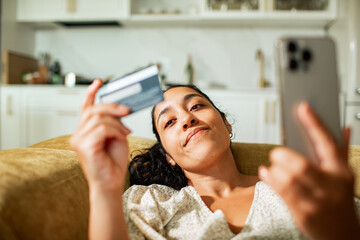Young woman shopping online at home