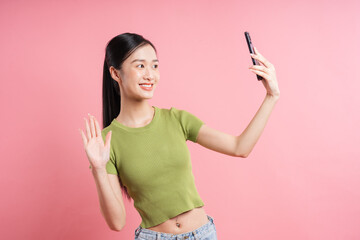 A young woman waves while on a video call She is smiling and appears very friendly