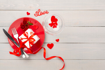 Festive table setting for Valentine's Day on wooden background, top view