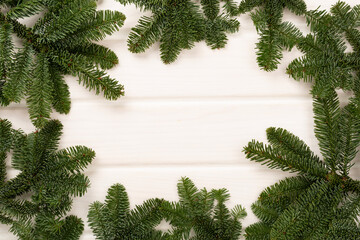 Christmas tree branches on wooden background, top view