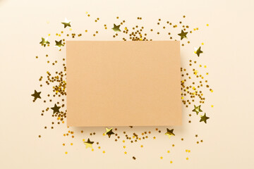 Golden star shape confetti on color background, top view
