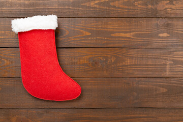 Christmas sock on color background, top view