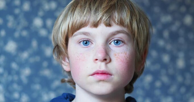 close-up portrait of a boy with blue eyes