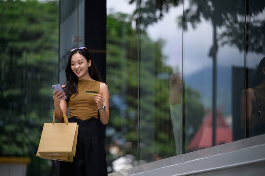 Woman paying online with credit card on smartphone