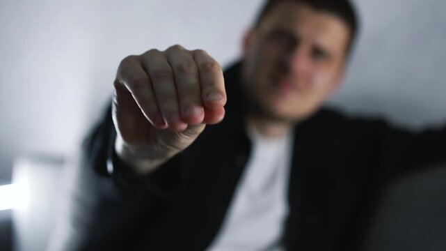 A man is hiding and teasing someone, making a blah-blah gesture.
A man makes a conversational gesture.
Lies and broken promises