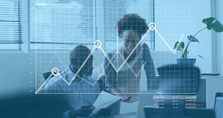 Collaborating two coworkers in office attire discussing report at desk, with line graph overlay