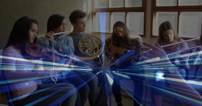 Conductor's baton directing six musicians playing violin, flutes, horn and guitar in studio