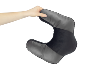 Neck pillow in hand, outstretched arm with neck pillow, isolated from background