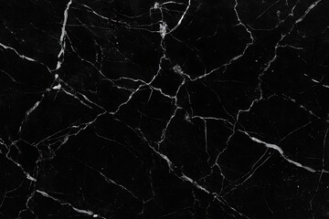 Close-up of black marble with intricate white veining, creating a natural and abstract pattern.