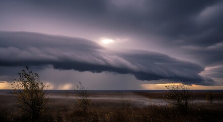 Fototapeta premium Dramatic storm clouds rolling over the horizon with ominous sky backdrop