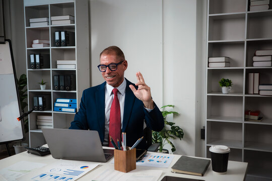 Businessman having video call meeting on laptop in office